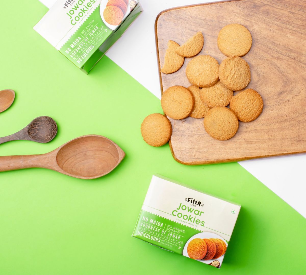 Food product photography, jowar cookies on a wooden board with the packs flat lay
